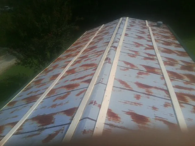 Rusted metal roof panels with new wood purlins before replacement — Storm Damage Roof Repair in Canyonville by Roofing Brothers
